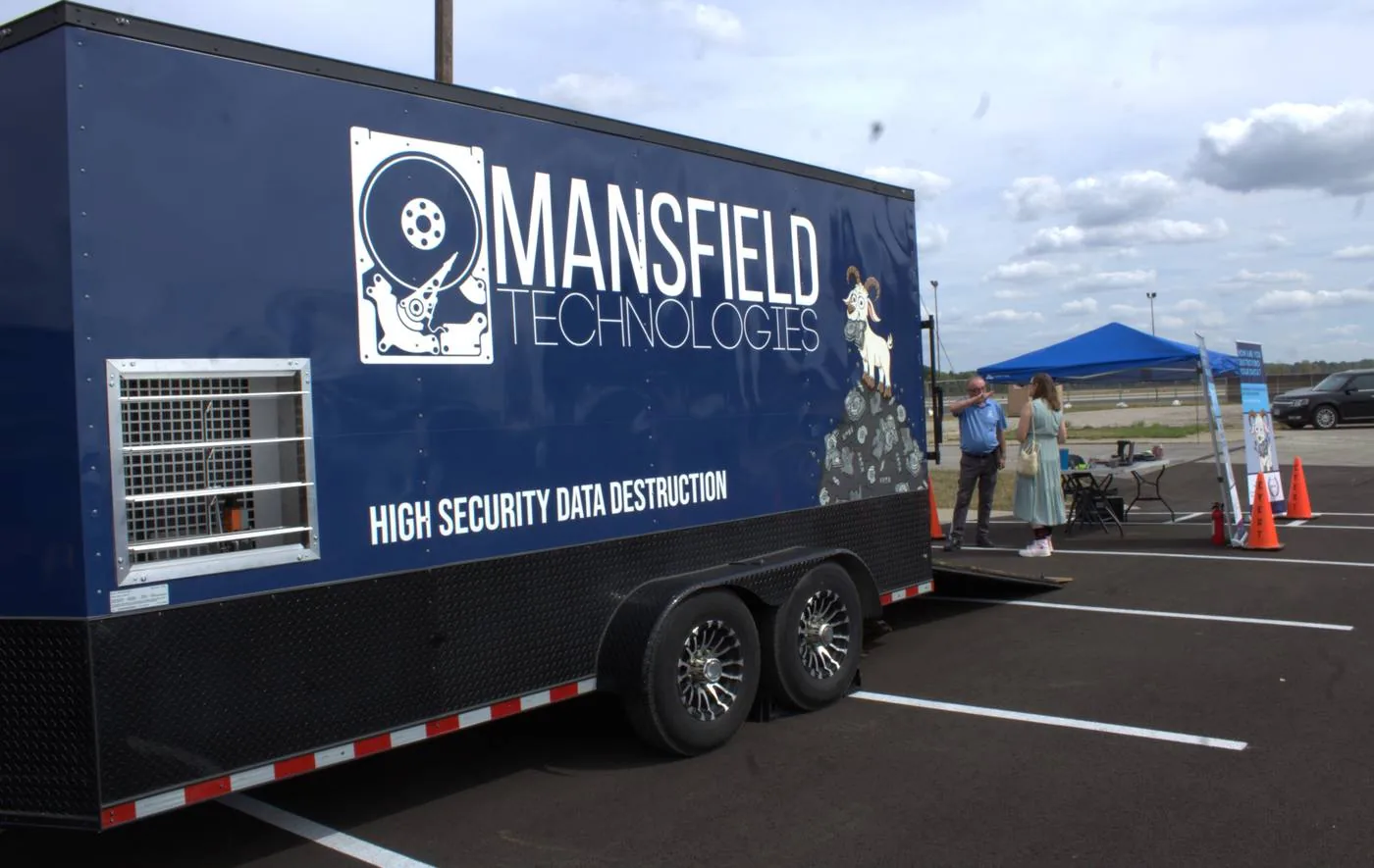 The navy Mansfield Technologies mobile shredding trailer
